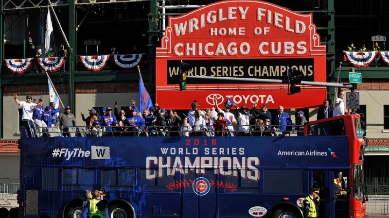 The Chicago Cubs celebrating during their World Series parade outside of Wrigley Field. 