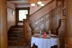 The gorgeous hard wood staircase. The stain glass picture of St. Cecelia sits upon these chairs. 