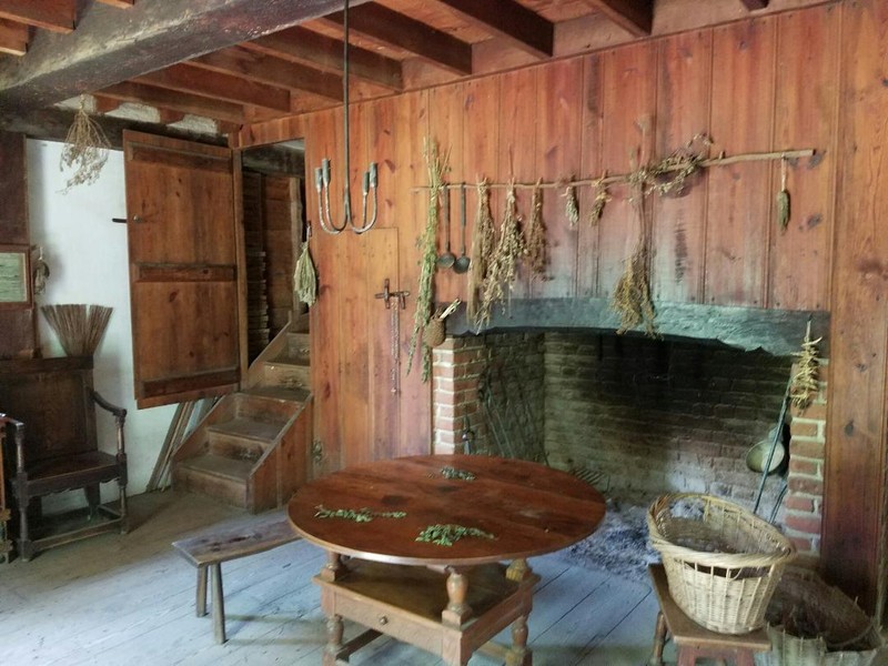 Inside the Plantation home, this is the main room with the large fire pit and rare family table. 
Photo by Amber Steffey