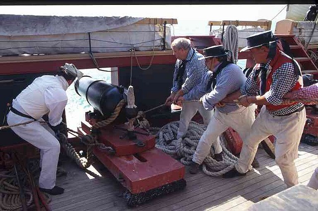 Sailors man the cannons during a re-enactment event.