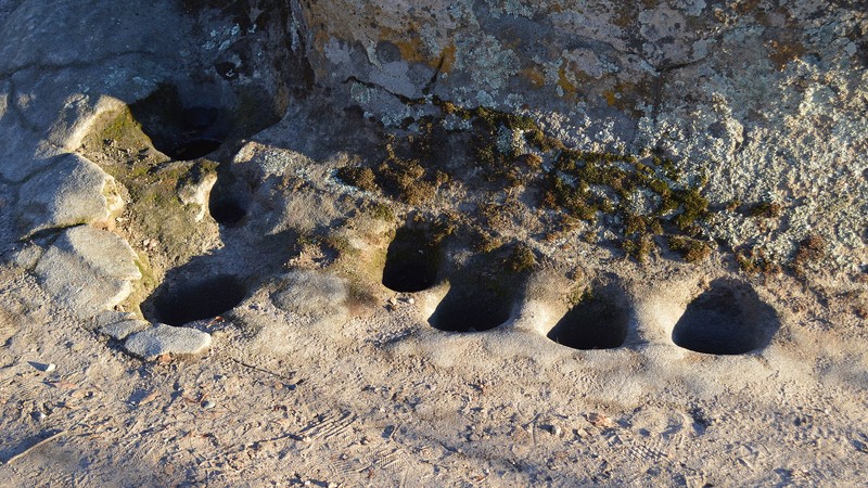 The site features numerous mortar holes like these.