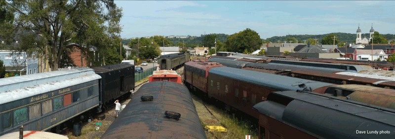 The Greater Cincinnati Railway Museum features dozens of train cars in an outdoor railyard environment. 