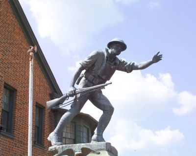 With his arms stretched forward and the gun at his side, the statue depicts the American infantryman as a heroic figure. 