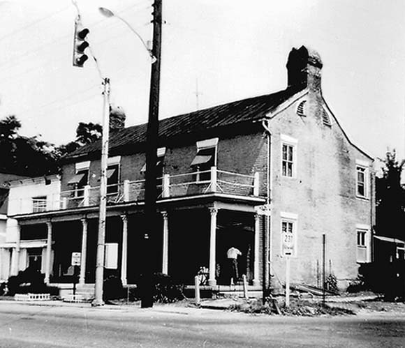 A view of the home in 1962 shows the house in a state of disrepair. The porch was removed but the rest of the structure was preserved.