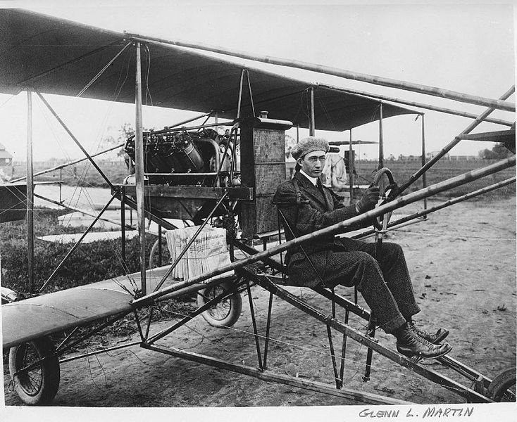 C. 1912, Glen L. Martin in a pusher bi-plane. Note the newspapers. Martin delivered papers in California as a promotional stunt.
