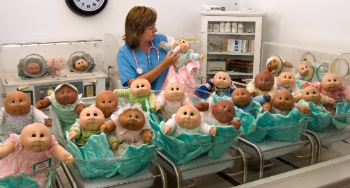 This is a picture of a 'nurse' taking good care of the Cabbage Patch babies. 