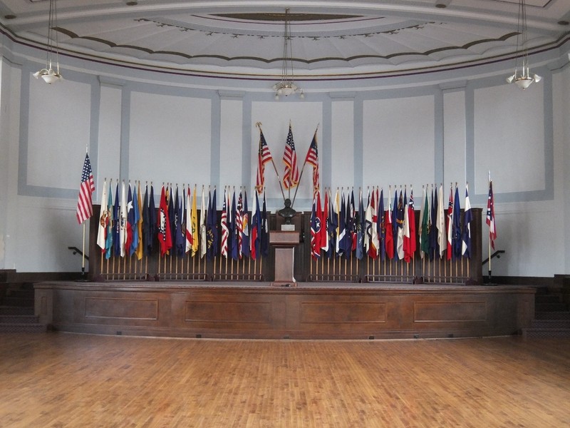 The auditorium stage features fifty state and four territorial flags, and a bust of William McKinley