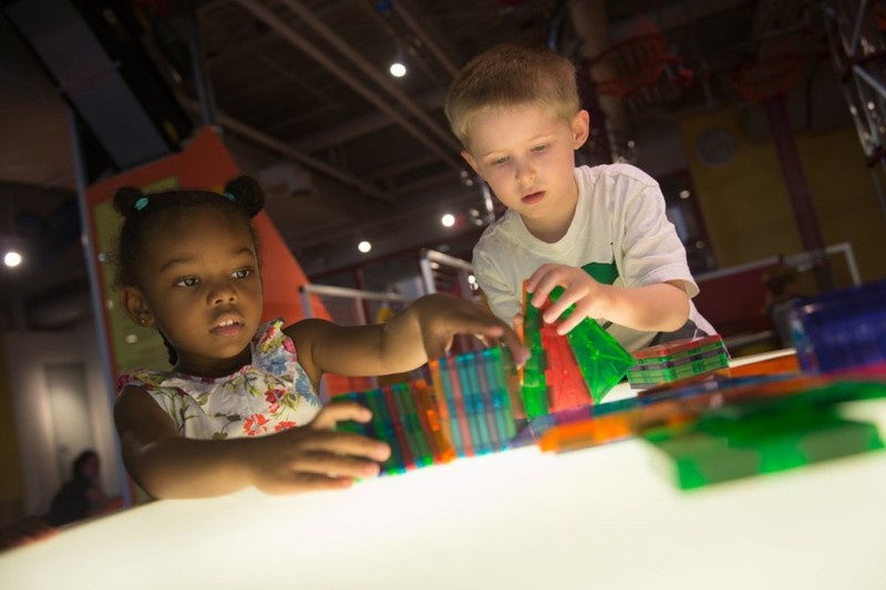 Kids work on the light tables