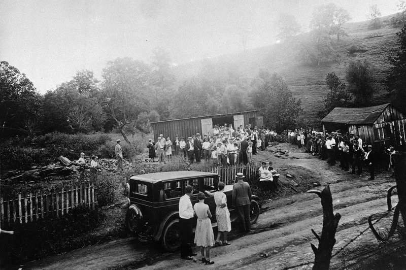 Community gathering around the "murder barn"