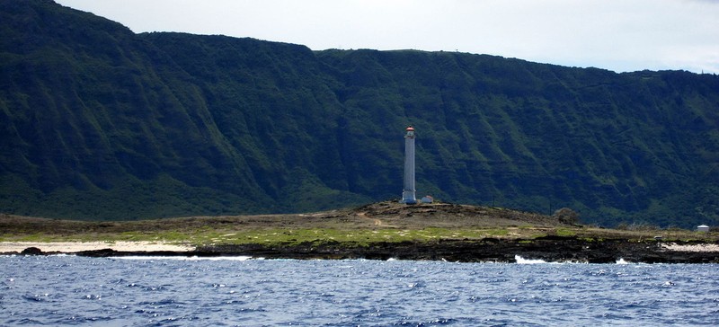 The light as seen from the water. The cliffs in the background rise 3,000ft high. 

Photo by: Mahalo Michael