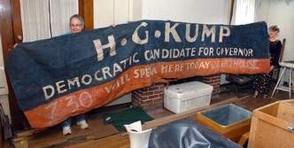 Sisters Scottie Roberts (left) and Heather Biola hold up an old campaign banner of their grandfather's. - See more at: http://www.wvgazettemail.com/Life/201208240224#sthash.uB1UILt7.dpuf