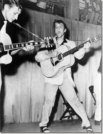 A now iconic photo of Elvis, this was taken during his performance at the armory. To the left is Scotty Moore 