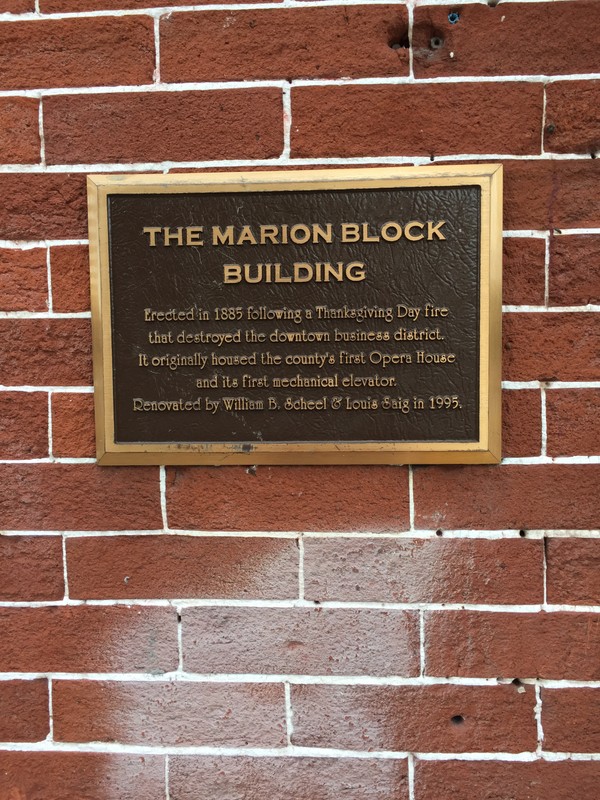 Plaque located on the 1st Ave side of building