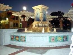 A water fountain that is located directly in front of the hotel. 