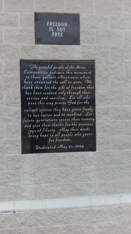 Picture of rear side of monument with inscription honoring all Raleigh County veterans who died.