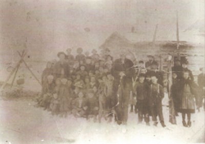 Teacher William Tidwell with his seventeen students in front of the school/cabin. Phot Cred. Jamie Powell