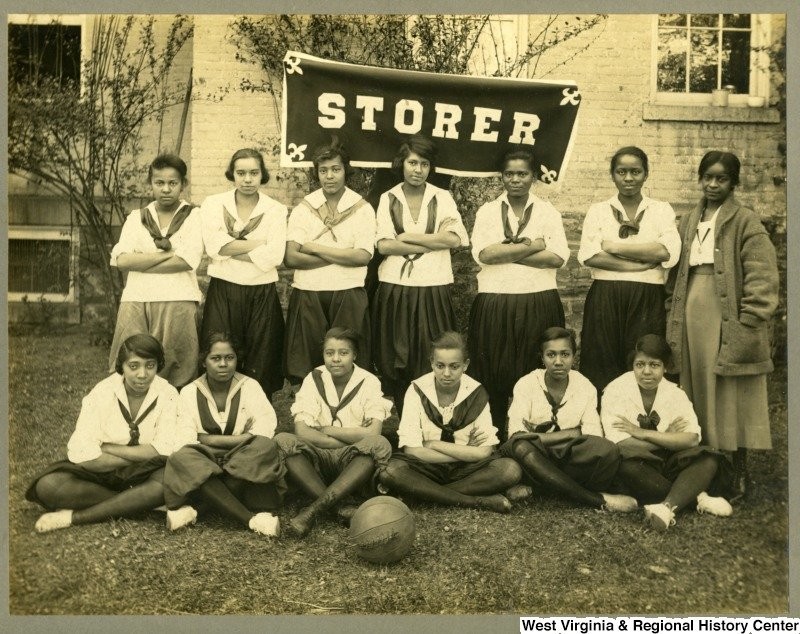 The girl's basketball team pose in their uniforms. Photo circa 1920, courtesy of West Virginia and Regional History Center, WVU Libraries.