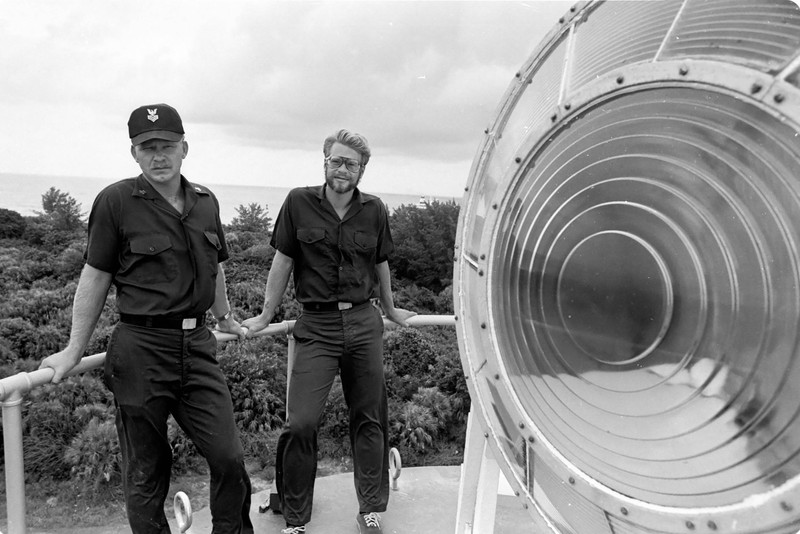 The lighthouse keepers of Egmont Key pose with the light lens (1980)