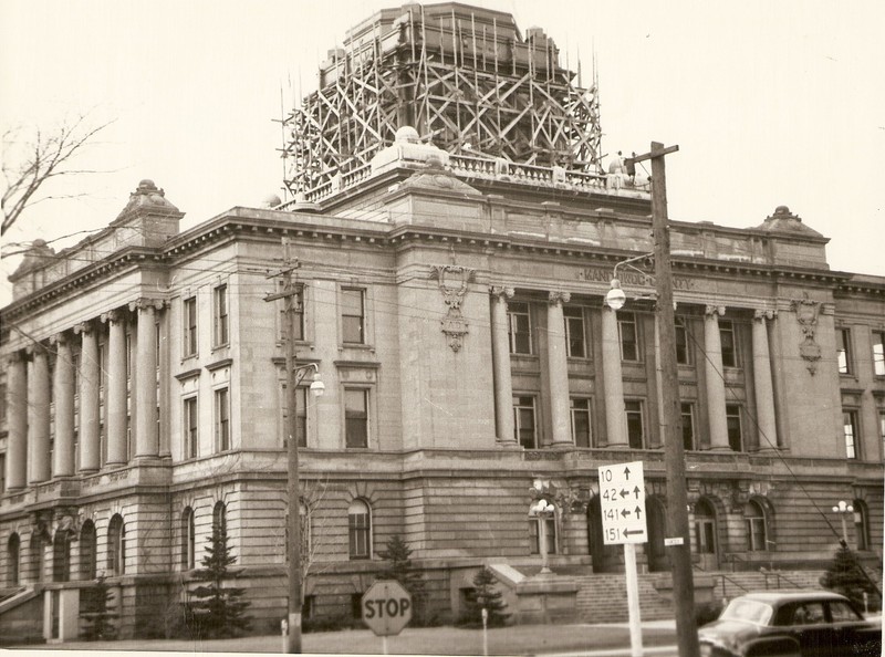 Manitowoc County Courthouse having maintenance done on it in early 1950s.  Looking east side from Hancock & S 8th St.