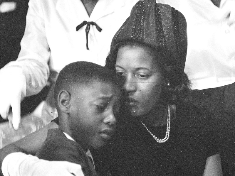 Myrlie consoles her son at the funeral of his father.