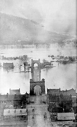 Oldest known photo of the Wheeling Suspension Bridge. Notice the flooded Ohio River, photographed 1852. Notice flooded Wheeling Island at the end of the bridge. W.C. Brown Collection.