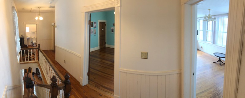 Moving from left to right. The bathroom is the first room, the back right corner is the entrance to the second bedroom, then the first bedroom with the robin egg blue walls, and last the entrance to second floor porch “sun parlor”.