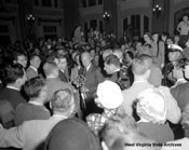 President Dwight D. Eisenhower accepting a key to the City of Wheeling, surrounded by a crowd in the B&O depot, September 24, 1952. J. J. Young Collection, West Virginia State Archives