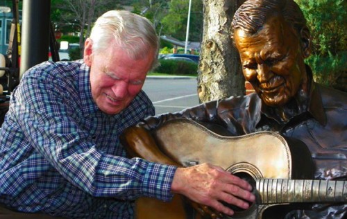 This 2011 photo shows Doc Watson as he is overcome by emotion as he feels the sculpture for the first time.