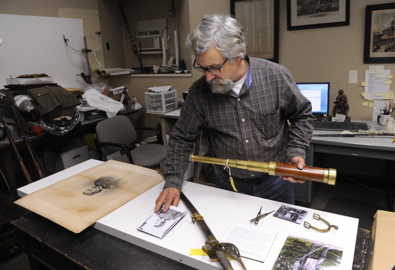 An archivist caring for some of the hall's artifacts.