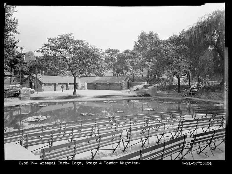 Same amphitheater with a small lake and seating during another time.