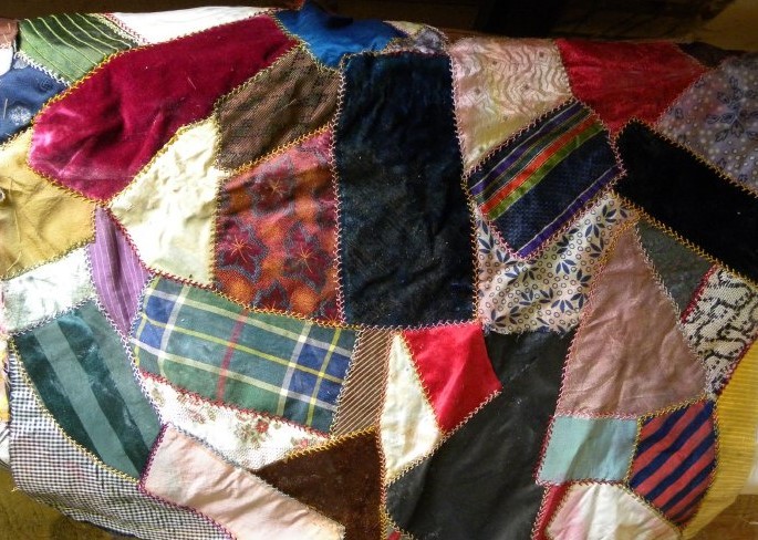 A 1930s example of a crazy quilt. Notice the elaborate, visible stitching and array of colors.