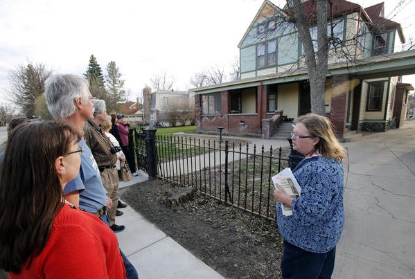 A volunteer leads a walking tour through the district