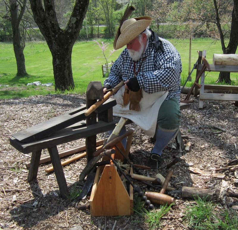 A volunteer woodworker demonstrating frontier techniques. 