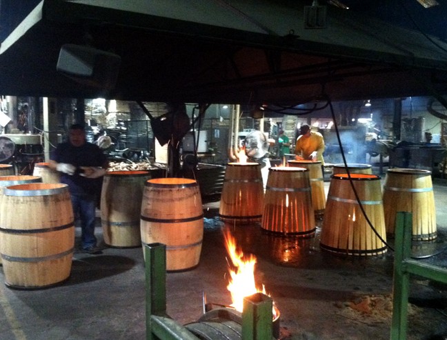 A view of the barrels before and after they are fired and charred. 