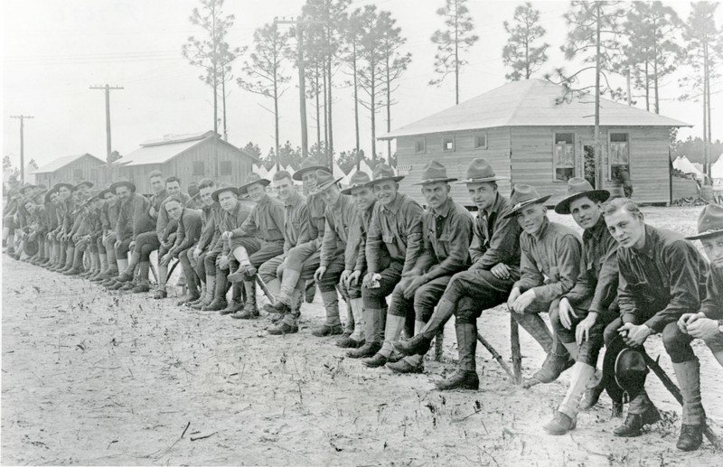 World War I soldiers, location unknown, 1918. The barracks in the background of this photo is similar to the one which was eventually repurposed as the Union Academy building now at Heritage Village. 