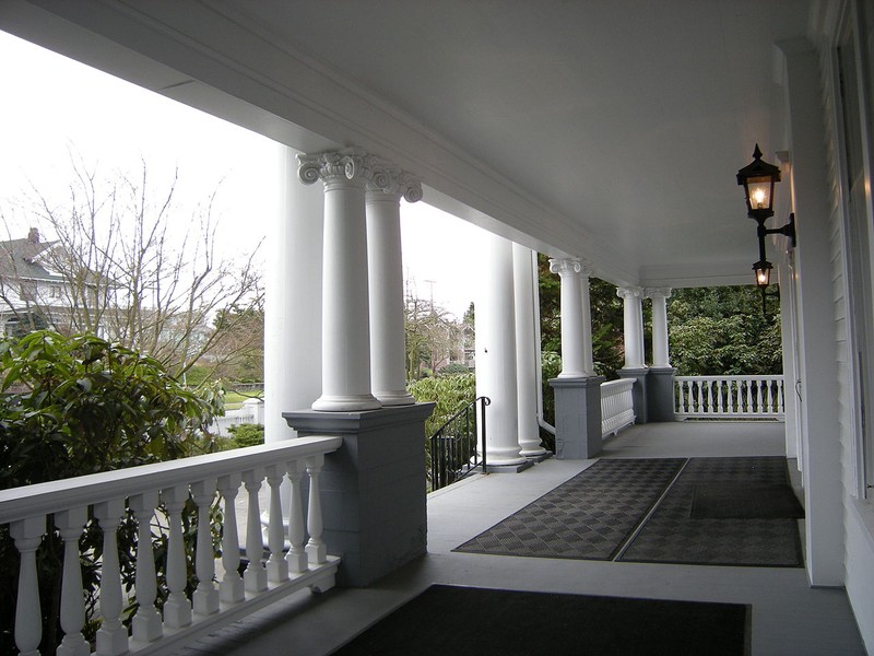 The house features a two-story porch with Corinthian and Ionic columsn.