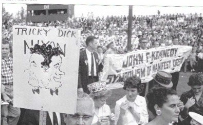 At the rally, onlookers hold up signs provided by The Young Democrats Club.