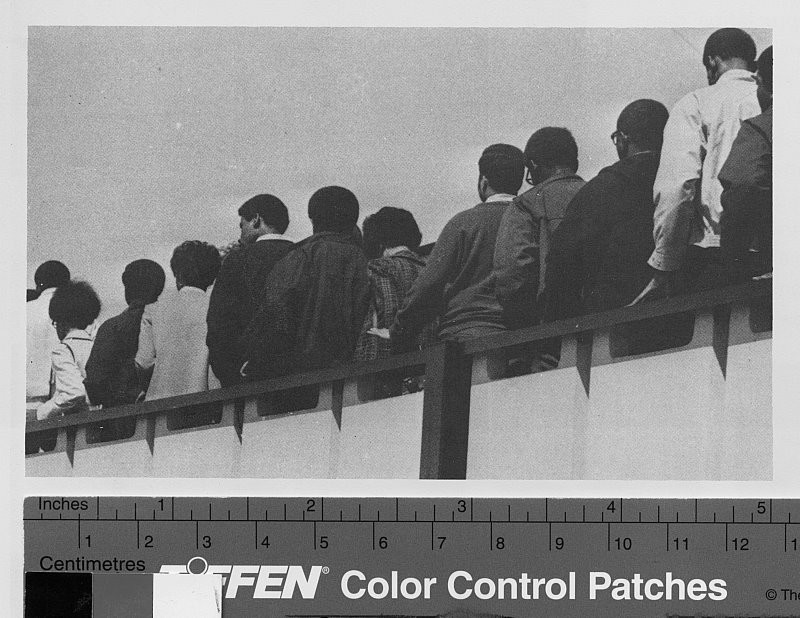Black student walk out of the Ficklen Stadium at President Leo Jenkin's convocation on March 31st, 1969.