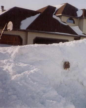 A snow bank in south Grand Forks with a mailbox showing halfway up the bank. Taken in March 1997