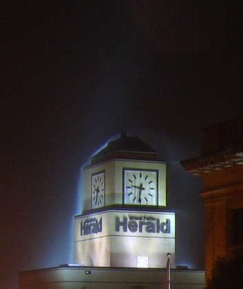 New Herald building and clock tower at night