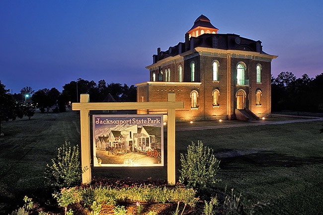 A colored photo of a building and sign taken together.