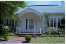 A 2005 photograph highlighting the details and expansive windows in the front of the house.