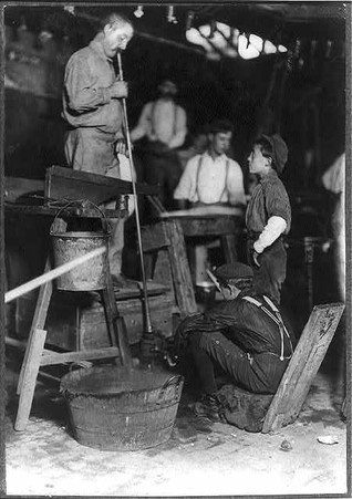 Photograph of a glass blower and mold boy by Lewis Hine, who documented child labor in the early twentieth century. Photo October 1908, courtesy of the Library of Congress.