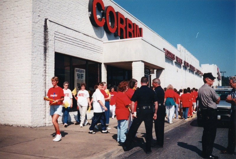 UNITE Union Protesters being questioned by police about activity and possession of necessary permits at Corbin Ltd. Factory Store at Huntington Mall, Barboursville, WV, 1996