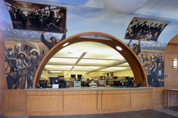 The library's main circulation desk is surrounded by this mural showing African American history and Black contributions to the city of Denver.
