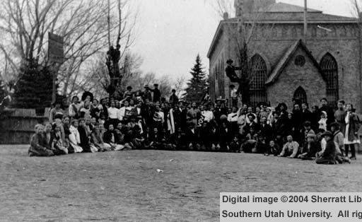 Photography courtesy of Southern Utah University Digital Library.  This image, depicting a group of people posing in front of the Cedar City Tabernacle, serves to indicate the importance and degree of use of the Tabernacle by the community.