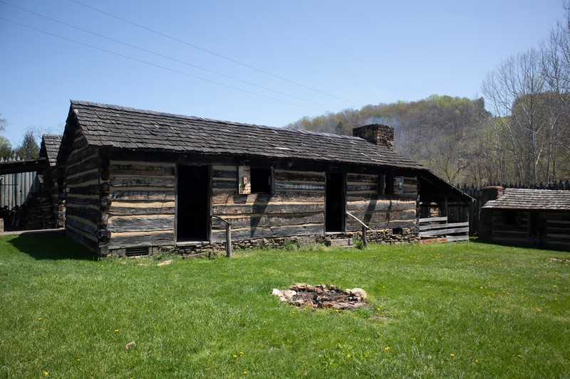 A large, long building made of logs situated in the middle of the inside of Pricketts Fort. It has two doors along its long wall.