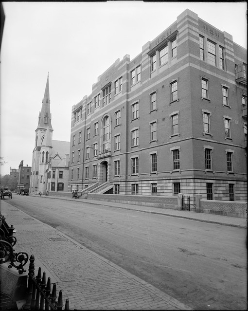 Black & White photograph of a brick building, crenellated roof.