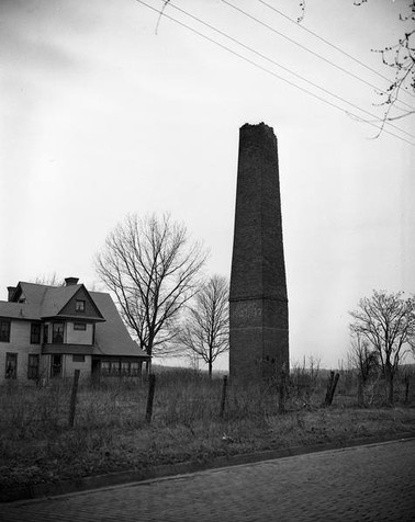 Photograph of the Buffington Mill smokestack before it was torn down