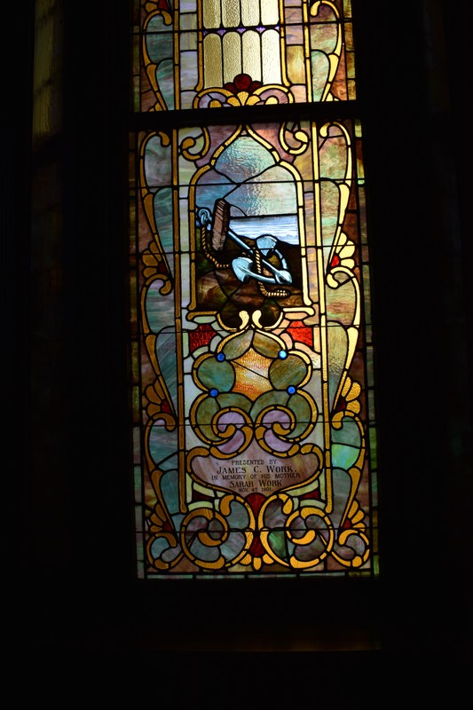 A scene on a stained glass window presented by James C. Work in honor of his mother Sarah Work.